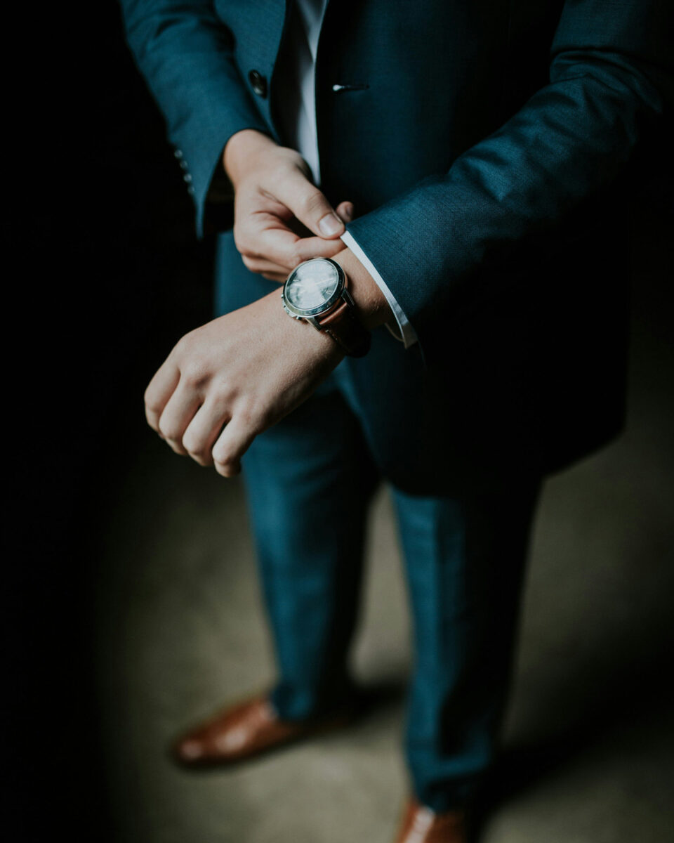 Man in a blue suit with a luxury watch on his wrist