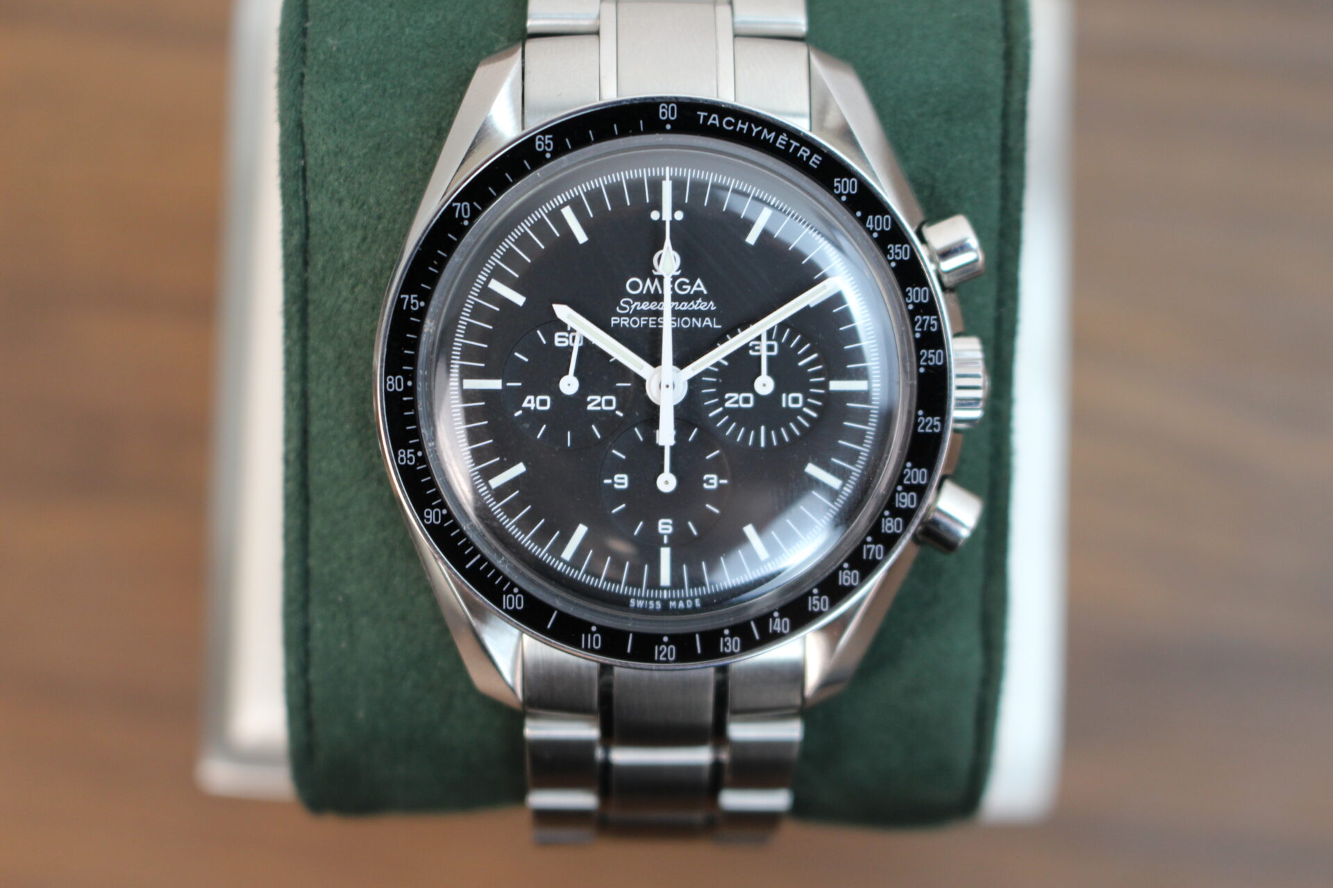 Omega Speedmaster Moonwatch Professional on a green cushion