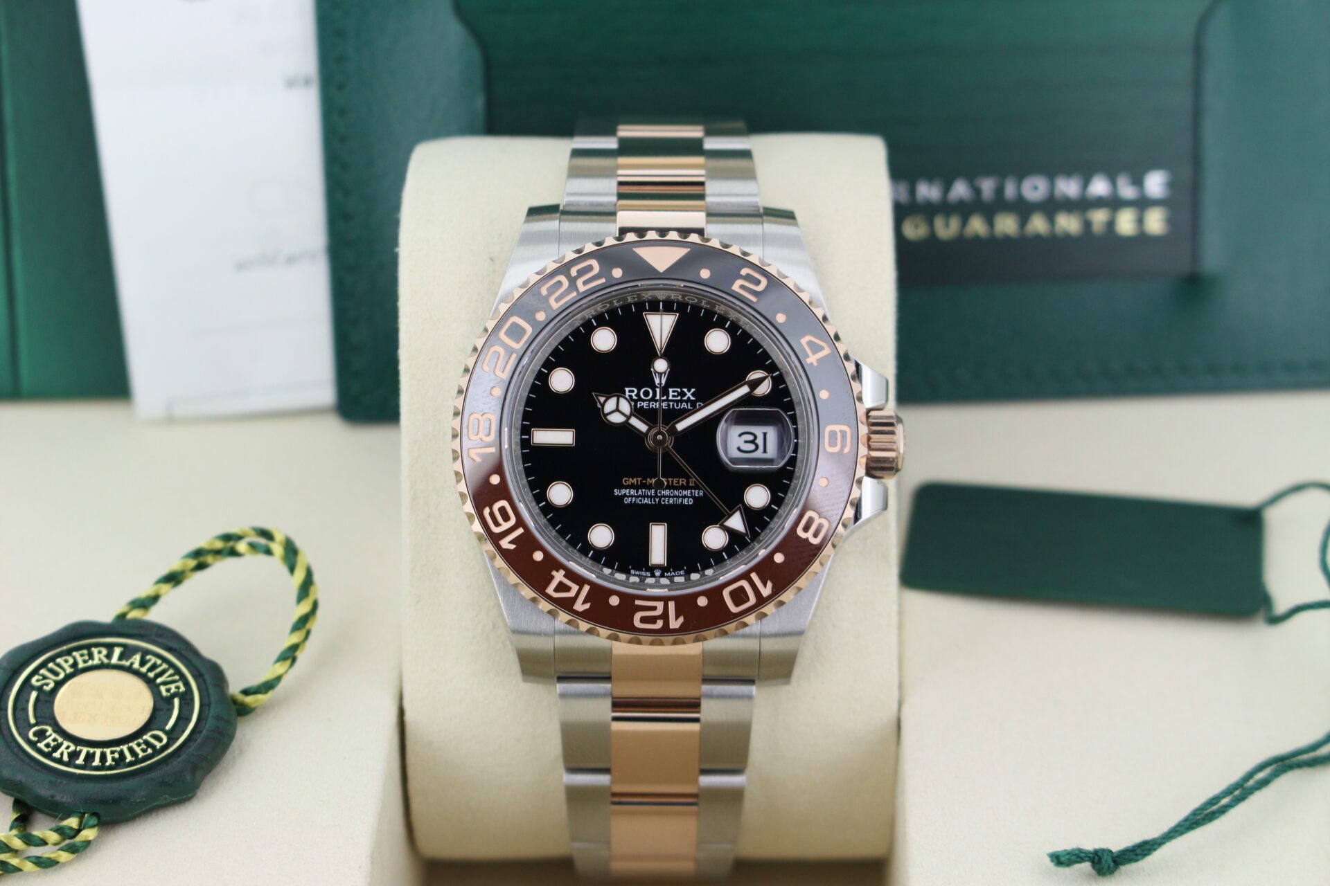 Close up of Rolex GMT Master II Rootbeer 126711CHNR in it's box with both swing tags, booklets, original purchase receipt and warranty card