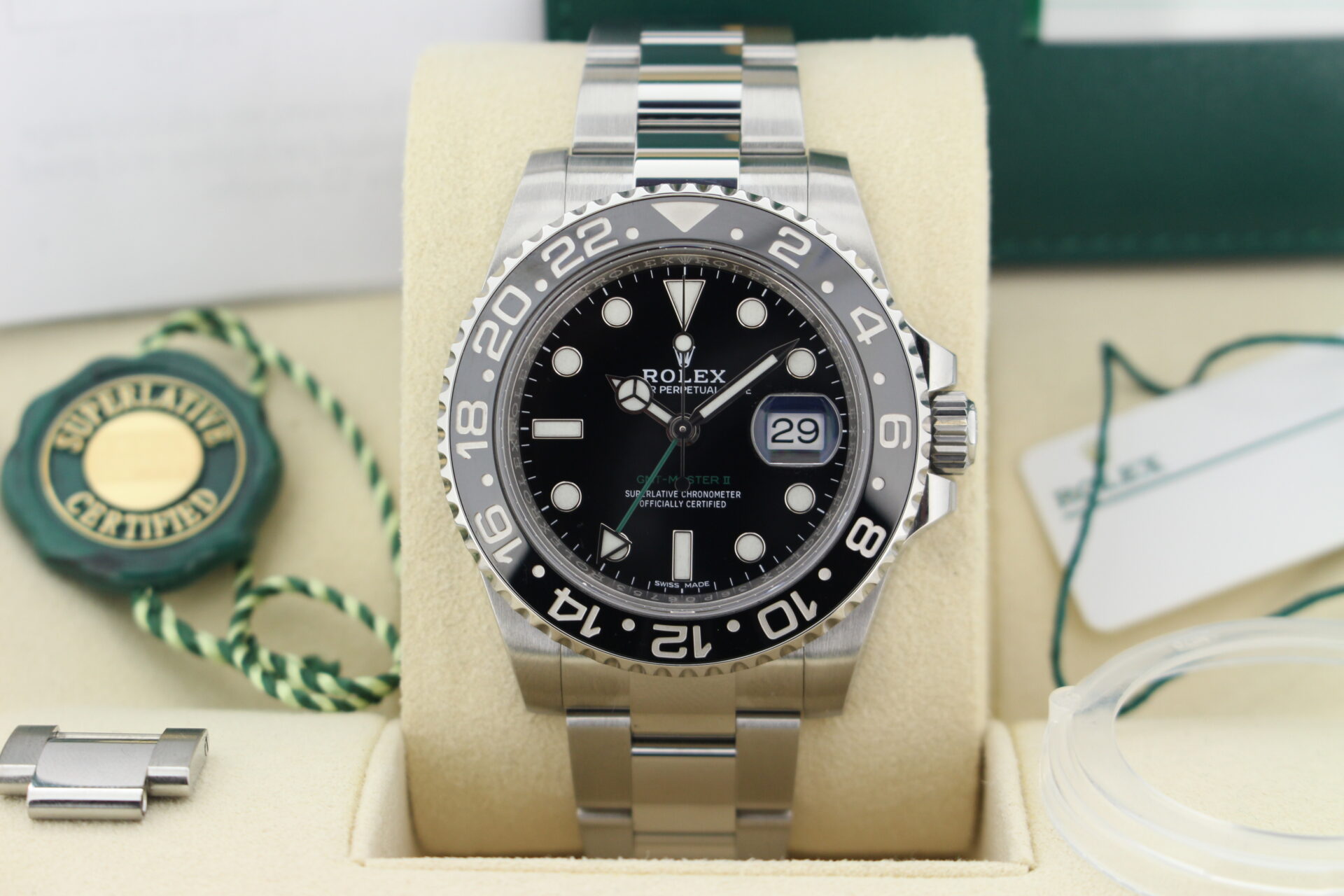 Close up of Rolex GMT Master II 116710LN in it's box with both swing tags, original purchase receipt, booklets and warranty card