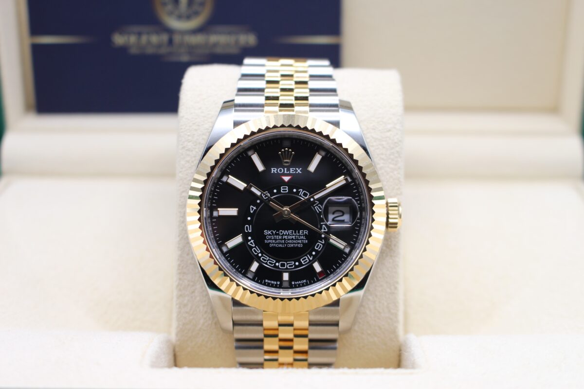 Rolex Sky-Dweller Black dial bi-metal watch upright on a watch cushion