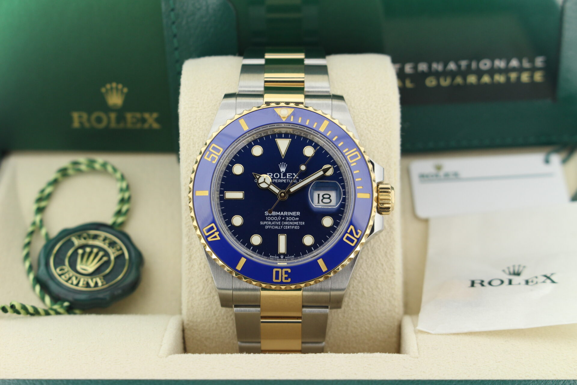 Close up of Rolex Submariner Bluesy 41mm 126613LB in it's box with both swing tags, booklets and warranty card