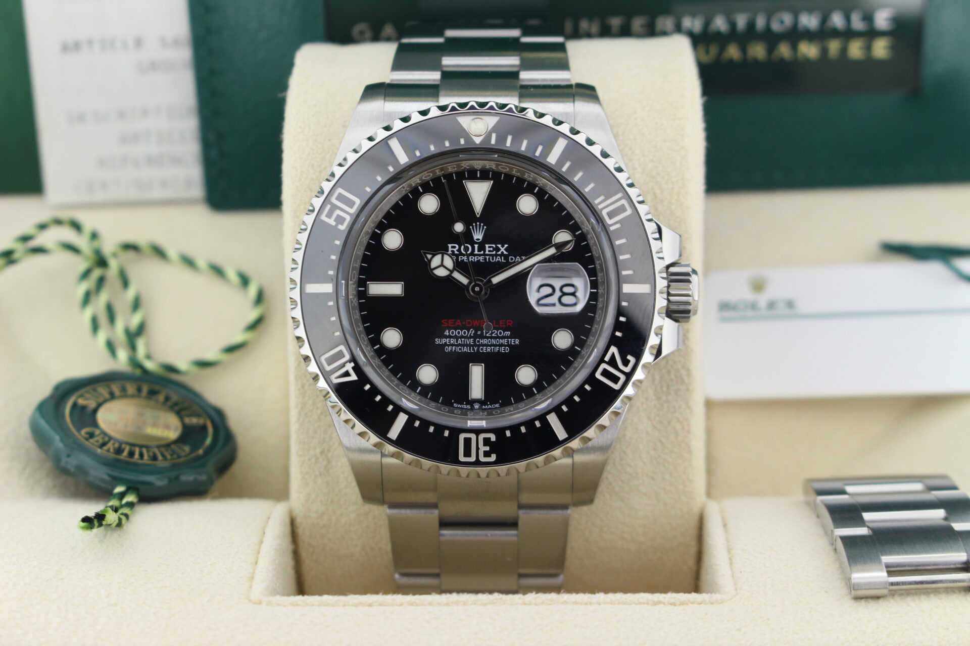 Close up of Rolex Sea-Dweller 50th Anniversary 126600 in it's box with both swing tags, booklets, original purchase receipt and warranty card