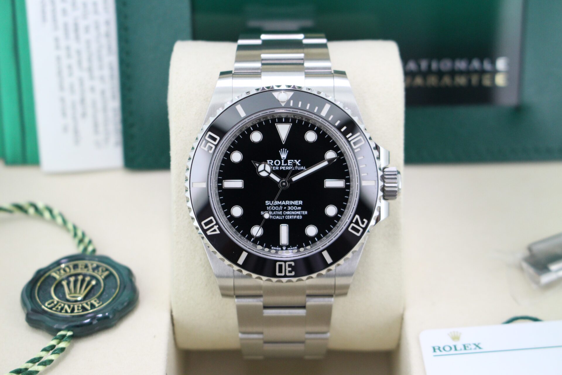 Close up of Rolex Submariner No Date 124060 in its box with both swing tags, booklets, original purchase receipt and warranty card
