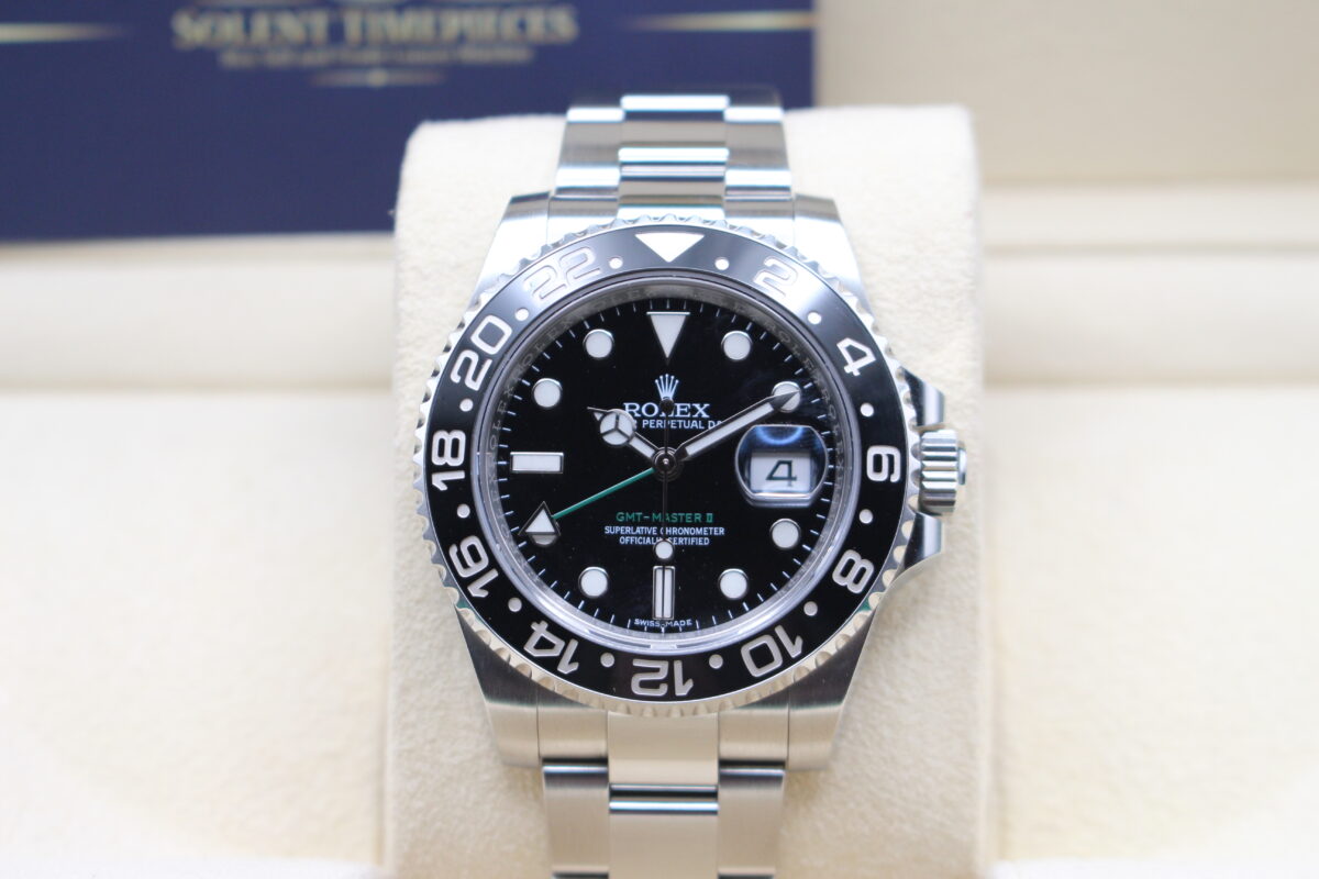 Rolex GMT Master 2 Black with an additional green hand. Sat on its watch cushion