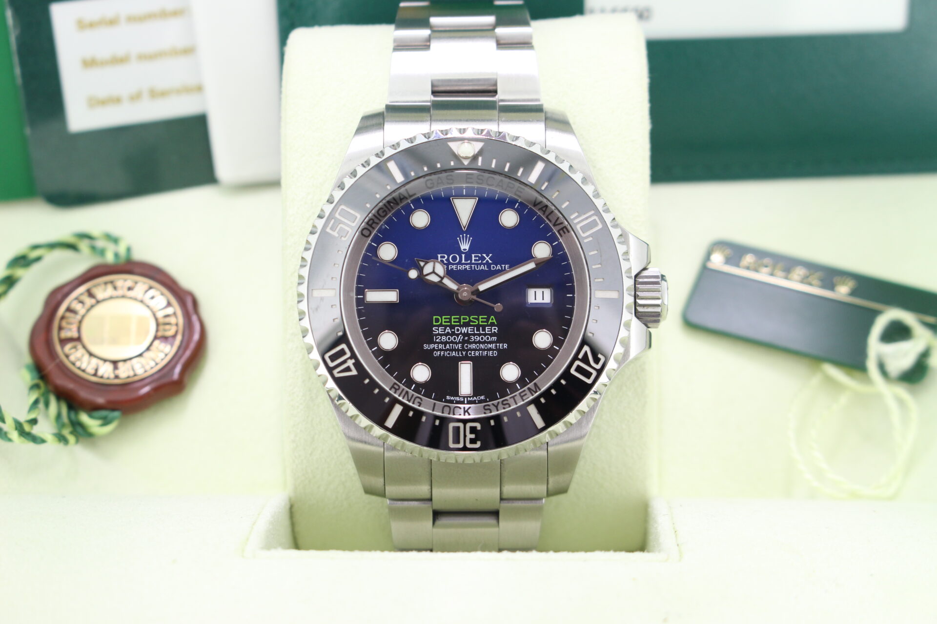 Close up of Rolex Deepsea James Cameron 116660 in it's box with both swing tags, booklets, service card and warranty card