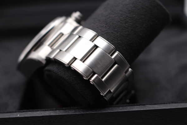 Tudor bracelet on a black bay on a black watch cushion