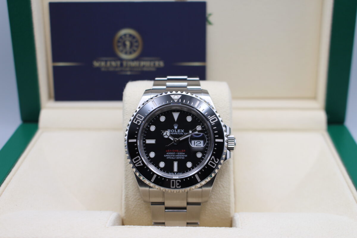 Rolex 126600 50th anniversary sea-dweller sat upright on a watch cushion in its box