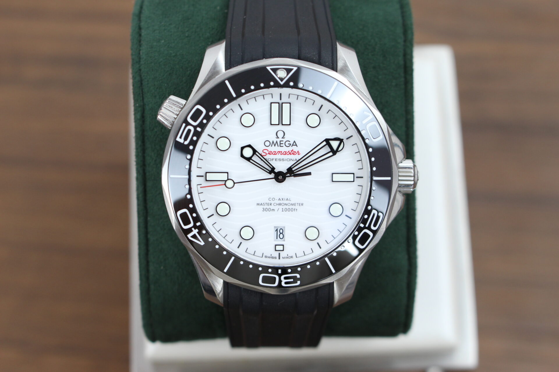 Omega Seamaster 300m White on a green cushion