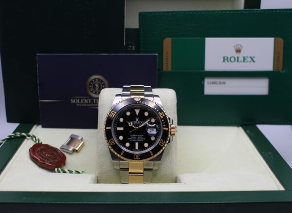 Rolex Submariner Bi-metal in its box, behind it is all papers and Solent Timepieces business card and next to it is its swing tags