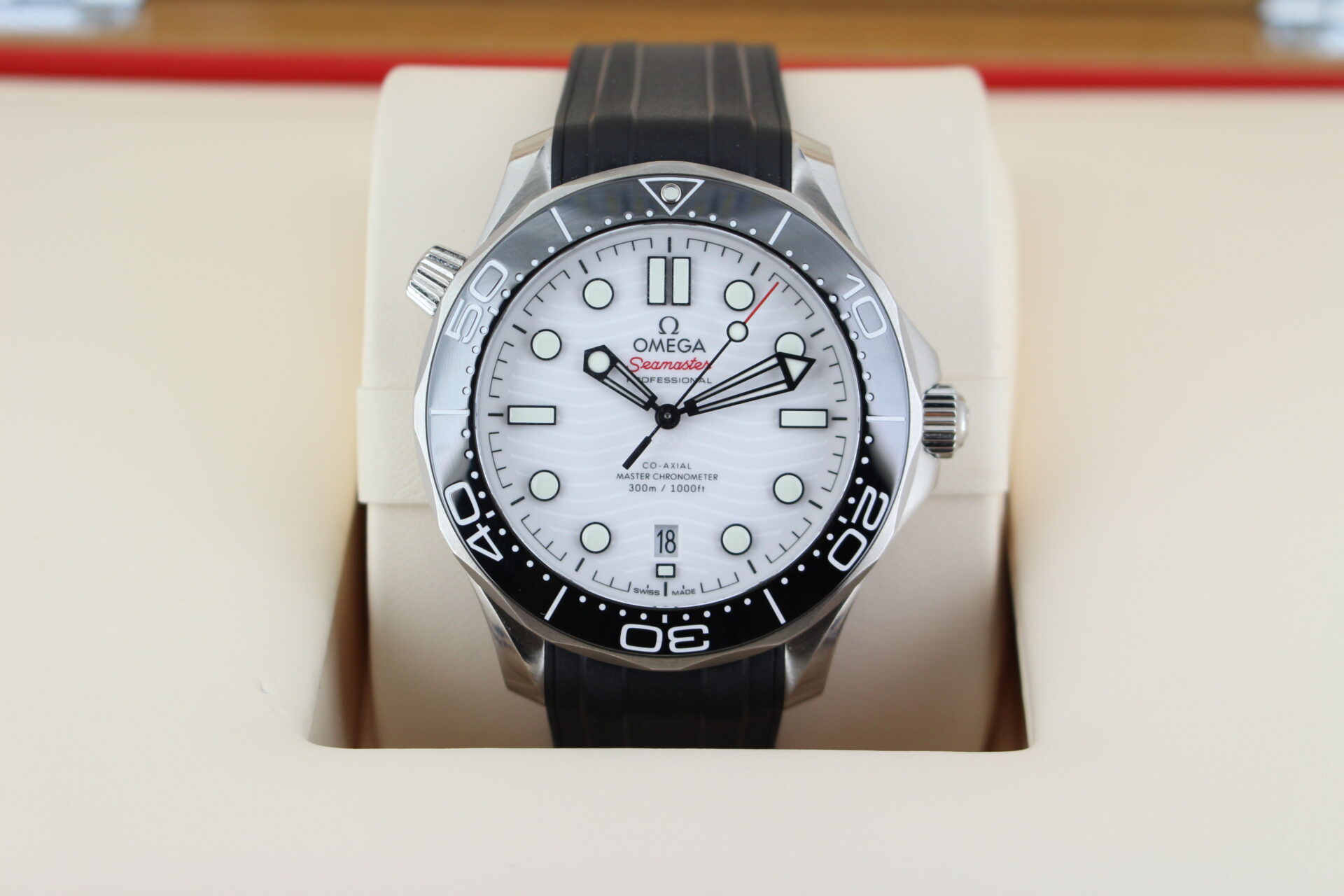 Close up of Omega Seamaster 300m White in it's box with booklets and warranty cards