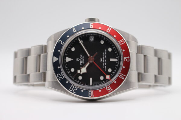 Tudor GMT Pepsi 79830RB on a white background laid on its side