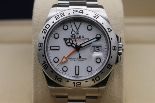 Close up picture of a rolex explorer II dial and orange GMT hand