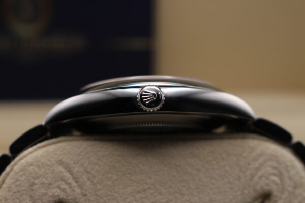 Rolex Oyster Perpetual 41mm on its side, show casing the crown