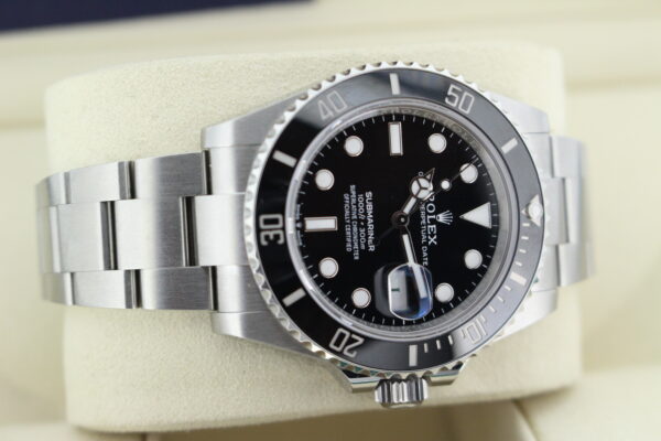 Rolex Sub date laid on its side on a watch cushion