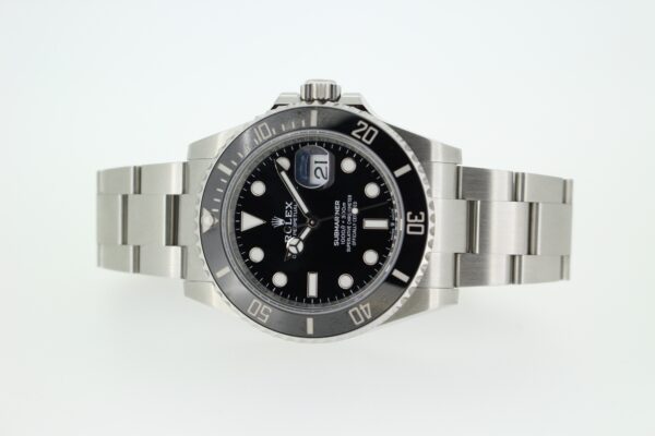 Rolex submariner 41mm laid on its side on a white background