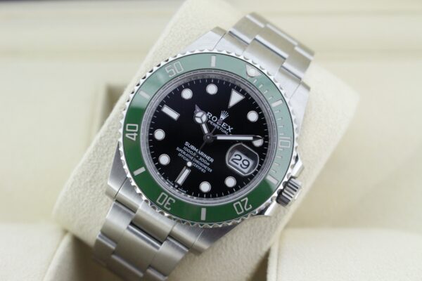 Rolex submariner Date displayed at an angle with the light reflecting on the dial