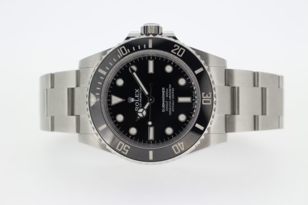 Rolex Submariner on its side on a white background