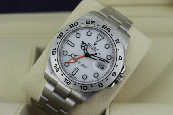 Rolex explorer 2 on its watch cushion leaned back with light reflecting on the dial