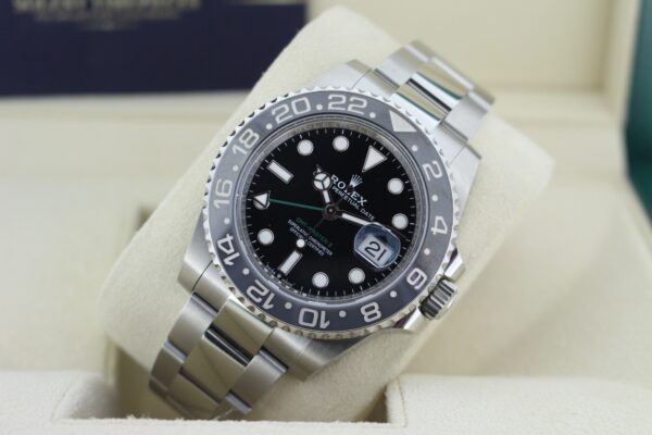 Rolex GMT Master II Bruce Wayne displayed at an angle with light reflecting on the dial