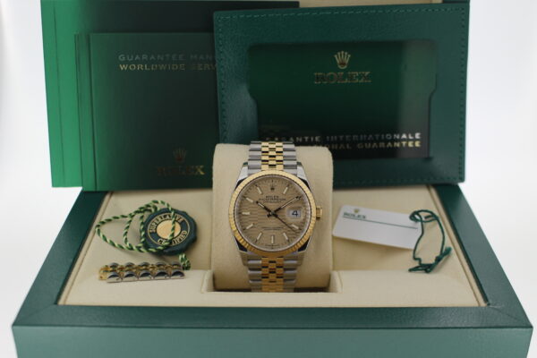 Rolex Datejust 36 with a discontinued motif champagne dial in its box with all original accessories making a full set