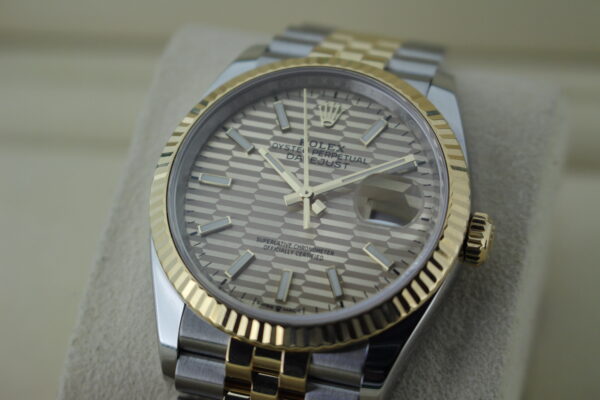 Angled shot of the motif dial light reflecting on the gold