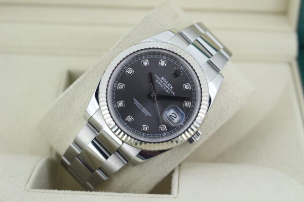 Rolex DJ 41 leaned back with light reflecting on the dial in its box