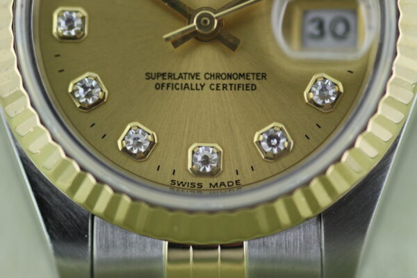 Close up of the factory champagne Rolex diamond dial
