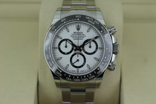 Rolex Daytona 'Panda' 126500 in it's box tilted up showing a black bezel, white dial and three black sub dials. The watch has an Oyster bracelet.