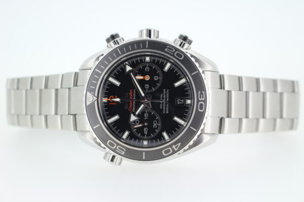 Omega Planet ocean on a stainless steel bracelet laid on its sid eon a white background