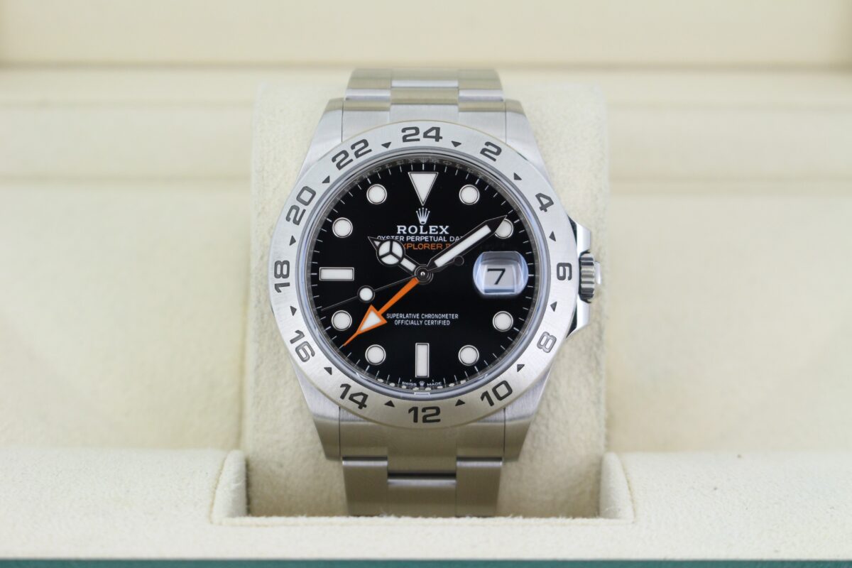Rolex Explorer II 226570 with a black dial, silver bezel and orange hands