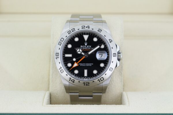 Rolex Explorer II 226570 with a black dial, silver bezel and orange hands