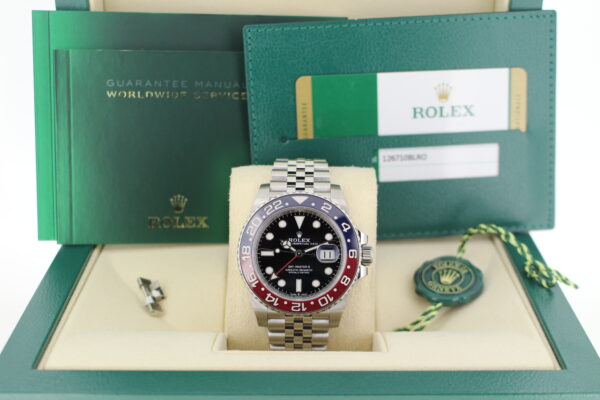 Rolex GMT Master II Pepsi 126710BLRO in it's box with green swing tag, spare link, booklets and warranty card.