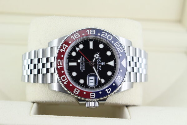 Rolex GMT Master II Pepsi 126710BLRO facing crown down in it's box, blue and red bezel