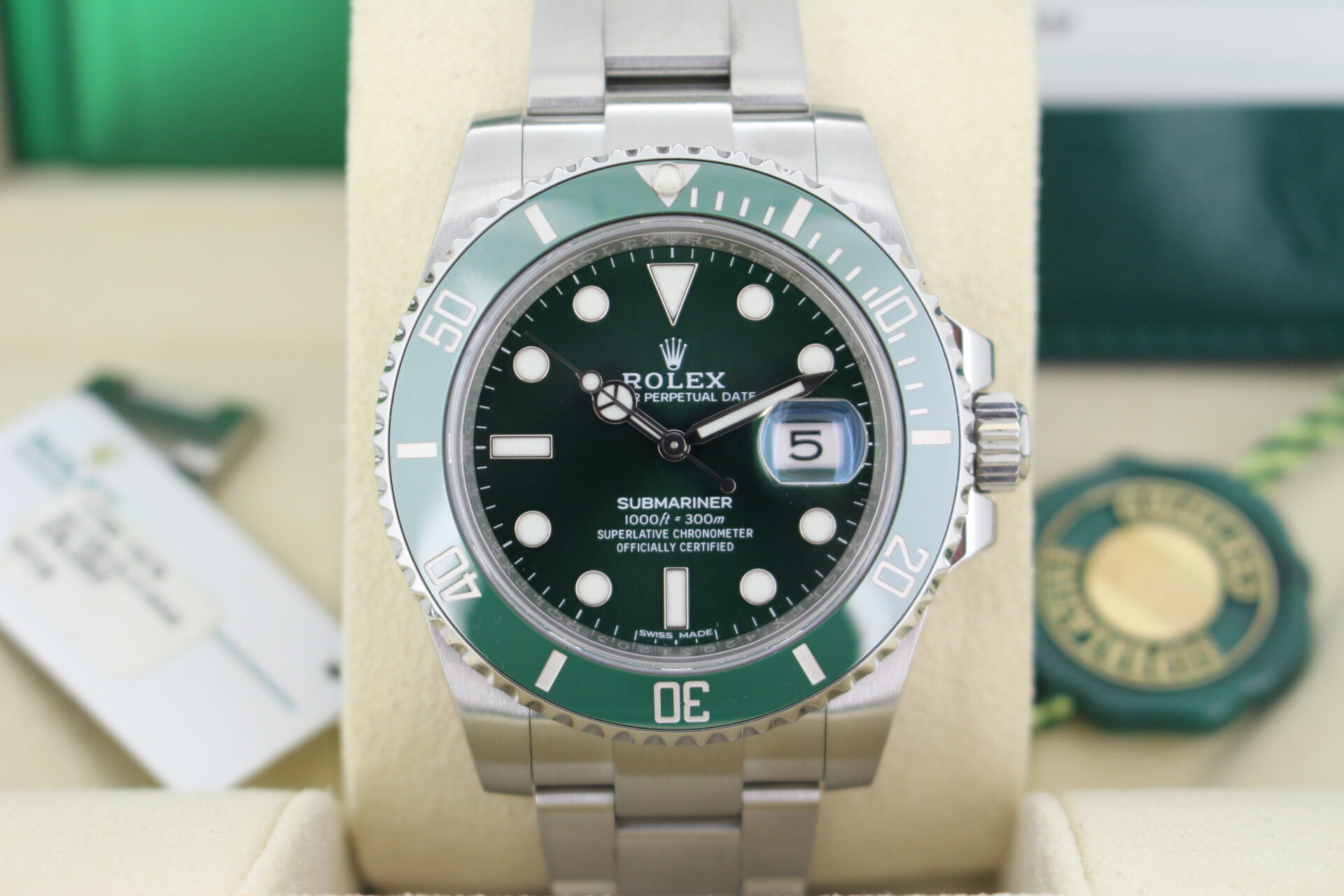 Rolex Submariner Hulk 126610LV close up of the watch in it's box with both swing tags, link, booklets and warranty card