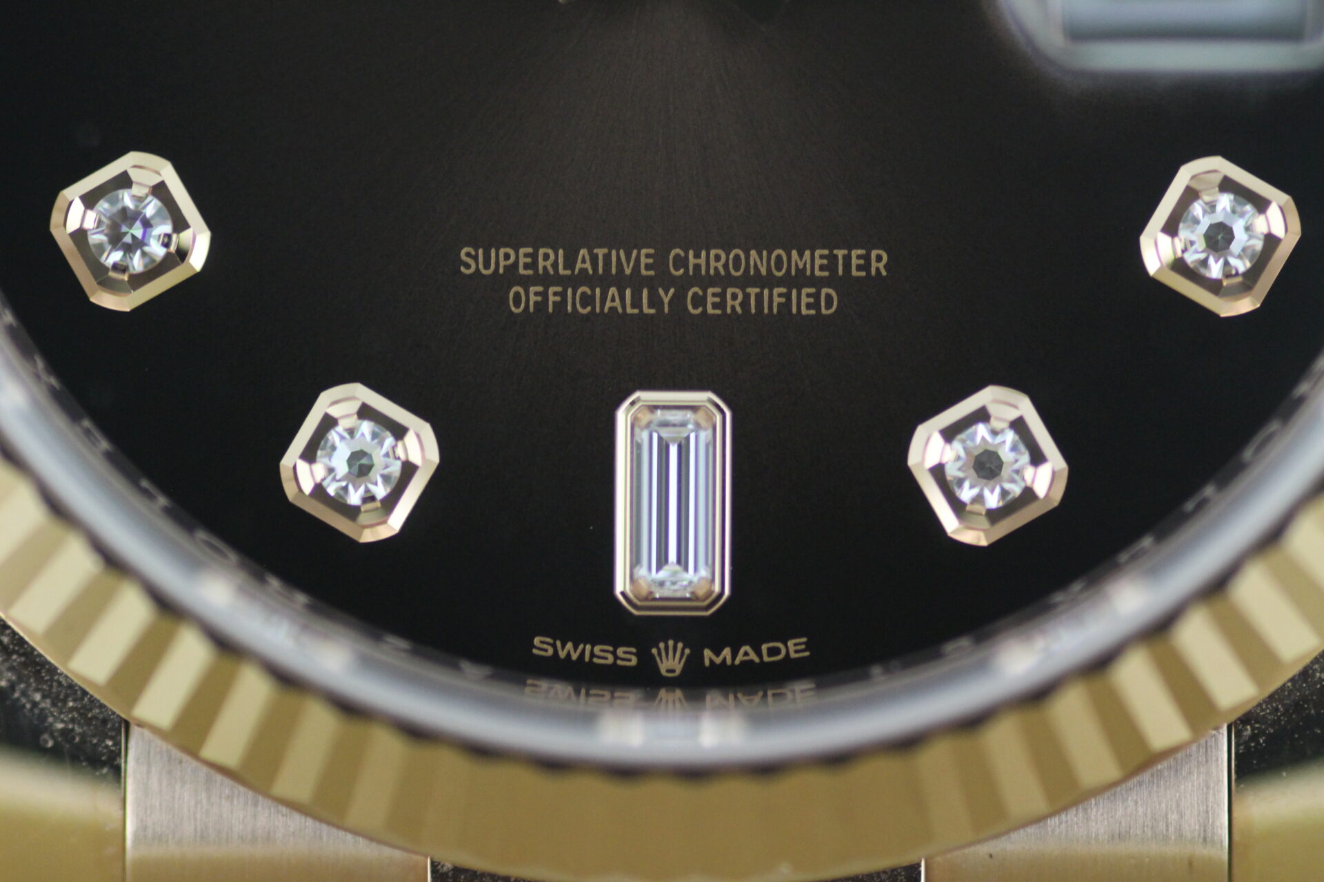 Rolex Day Date Chocolate Dial 128235 close up of dial showing 'Swiss Made' logo and diamond indices