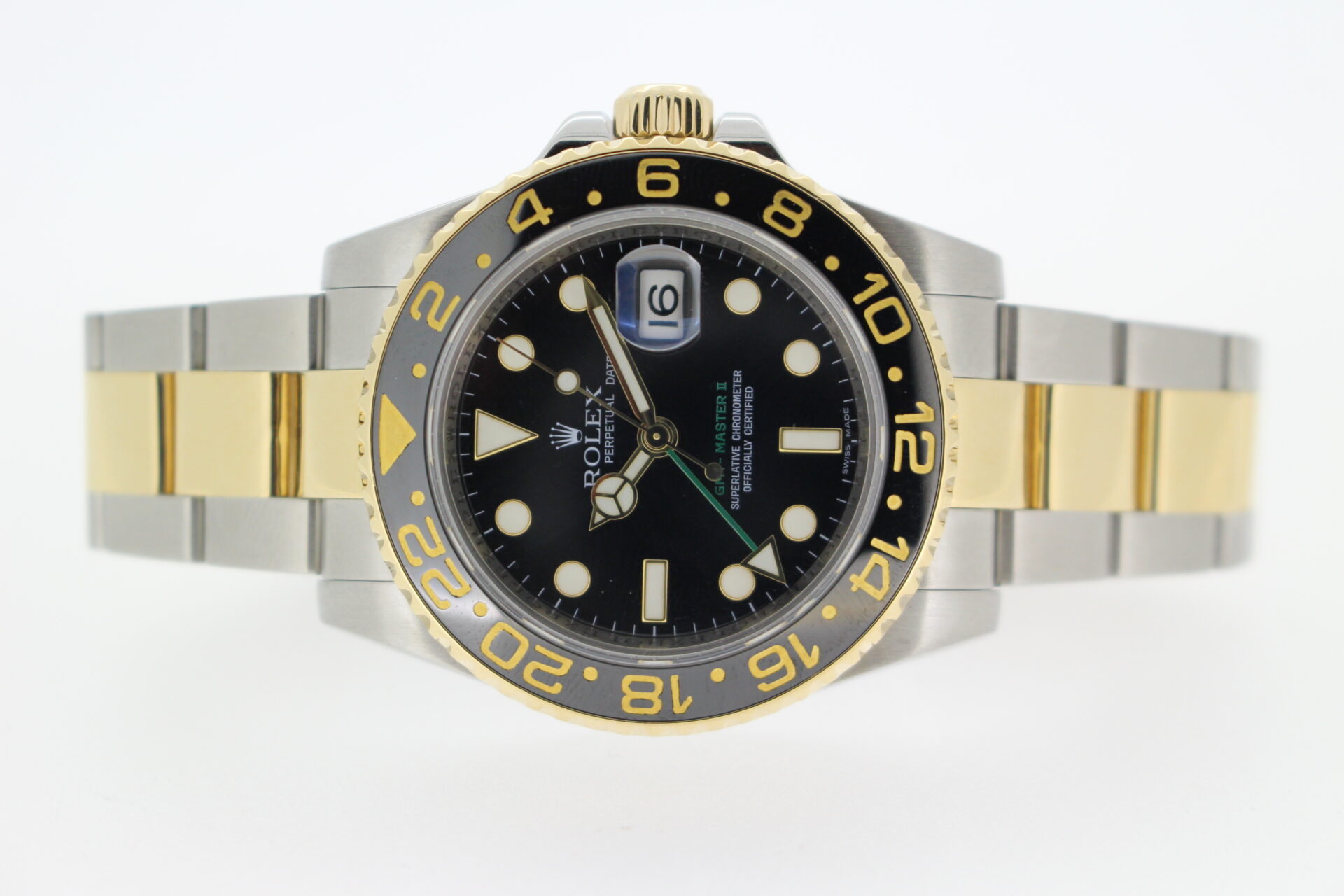 Rolex GMT watch laid on its side on a white background