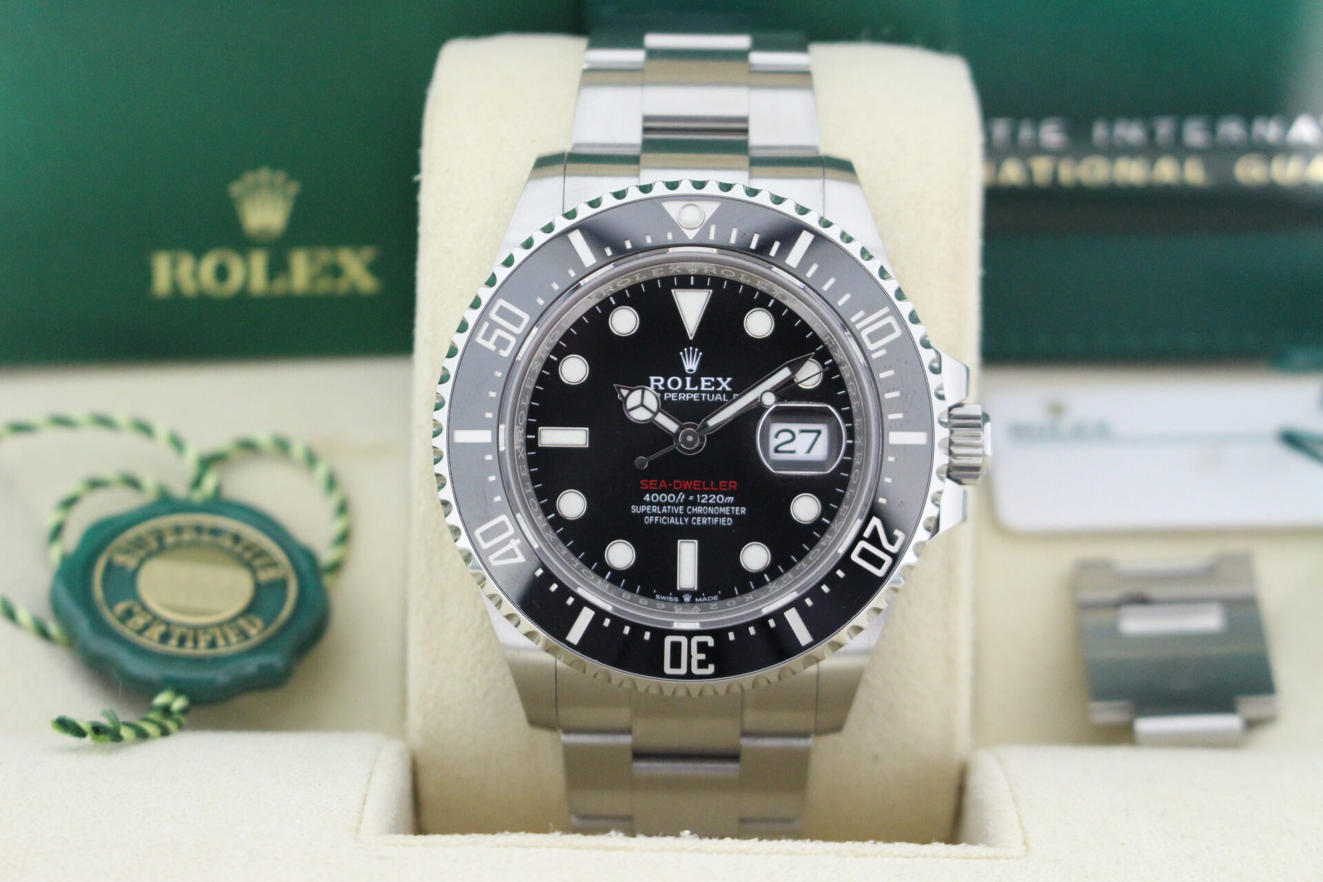 Close up of Rolex Sea-Dweller 126600 50th anniversary edition in it's box with booklets, warranty card and both swing tags