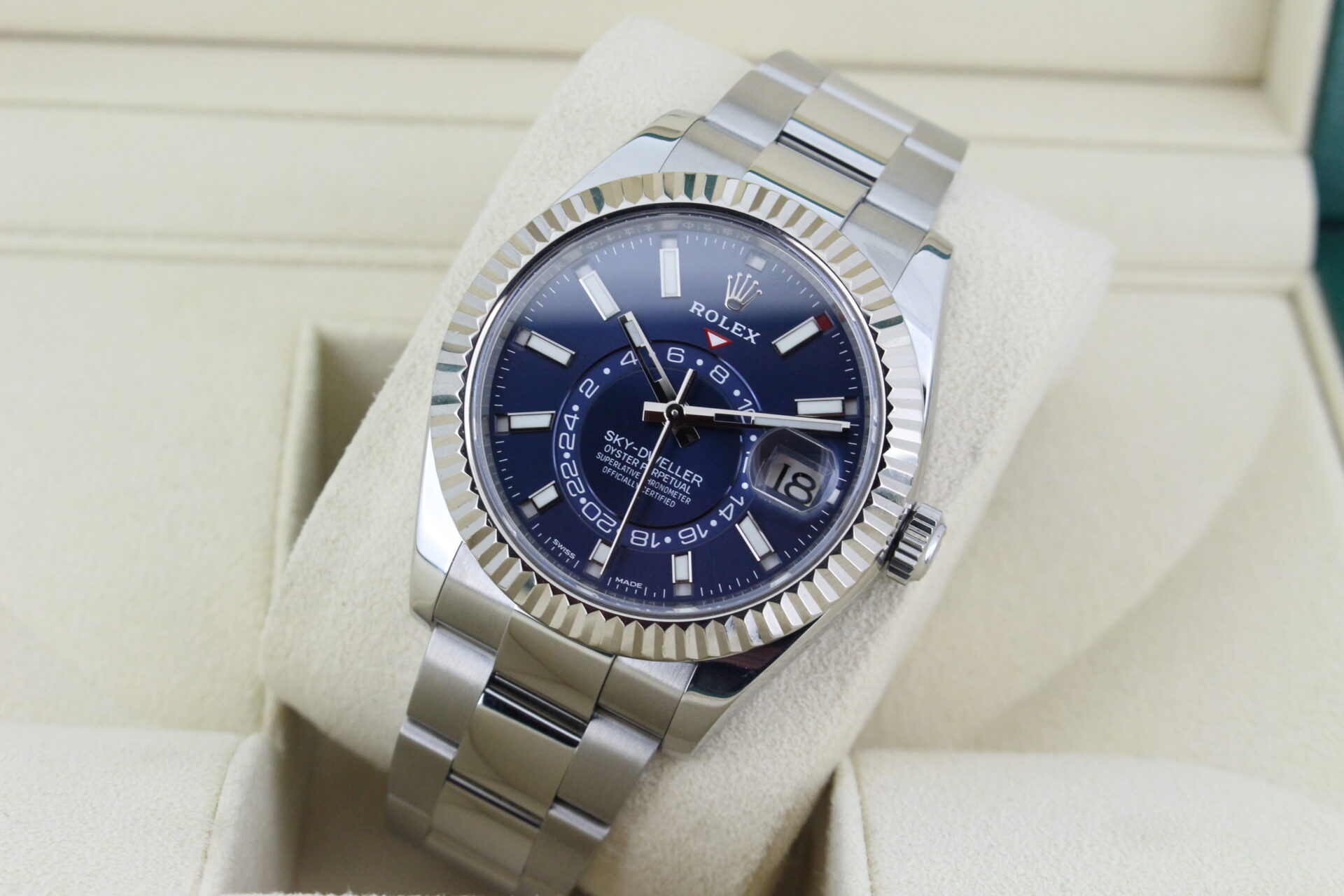 Sky Dweller in its box leaned back with light reflecting of the dial