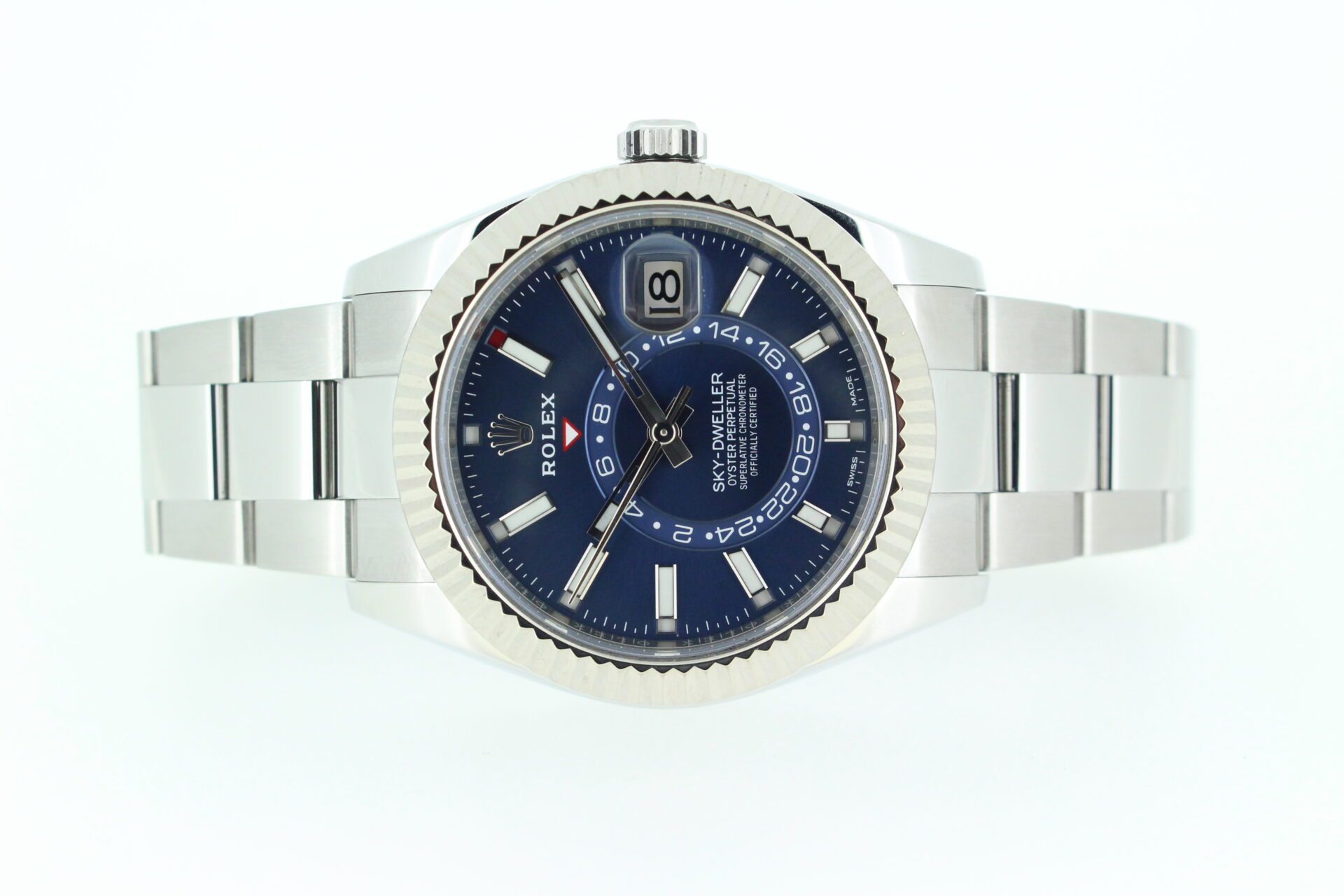 Rolex Sky Dweller blue dial laid on its side on a white background