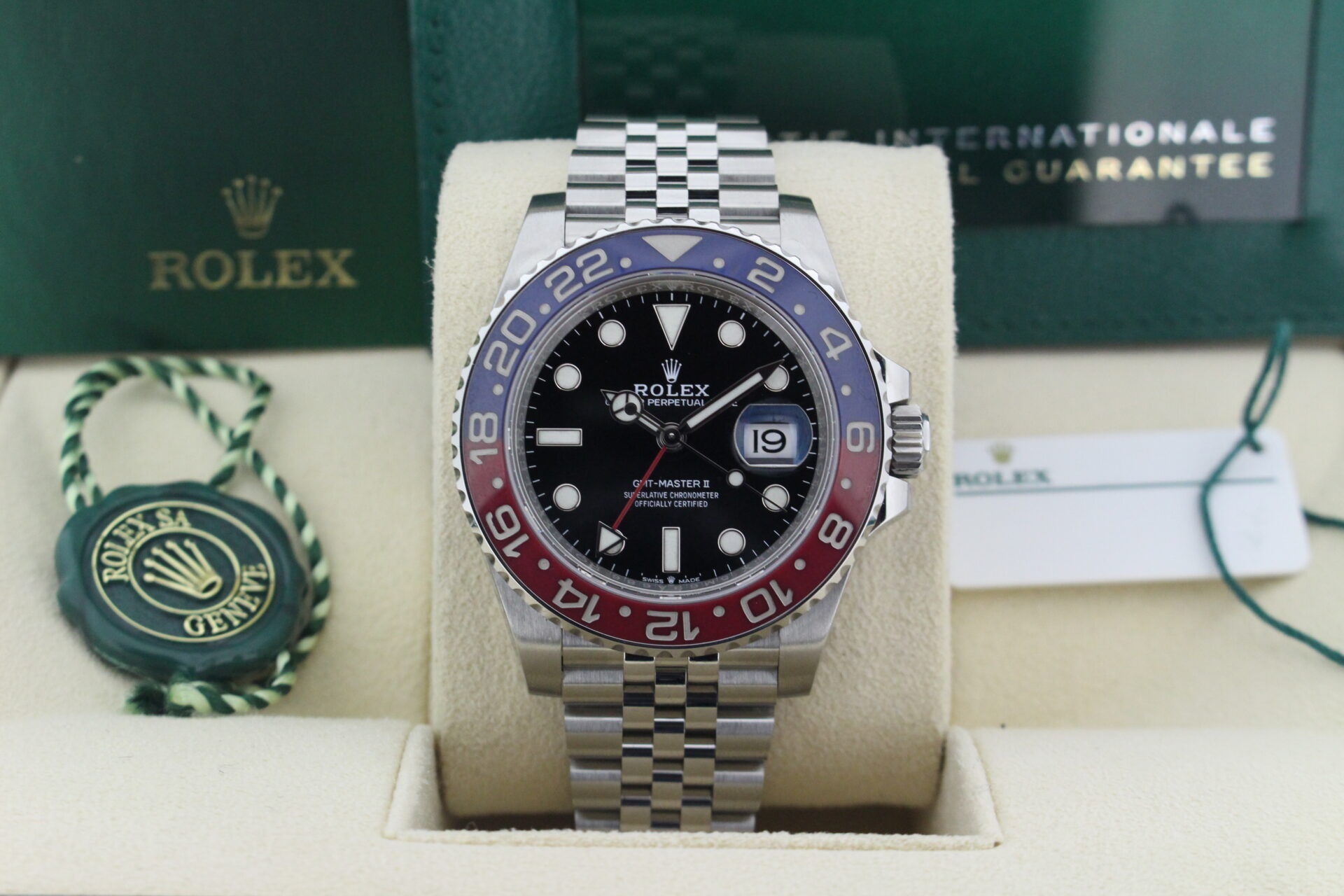 Close up of Rolex GMT Master II Pepsi 126710BLNR in it's box with both swing tags, booklets and warranty card