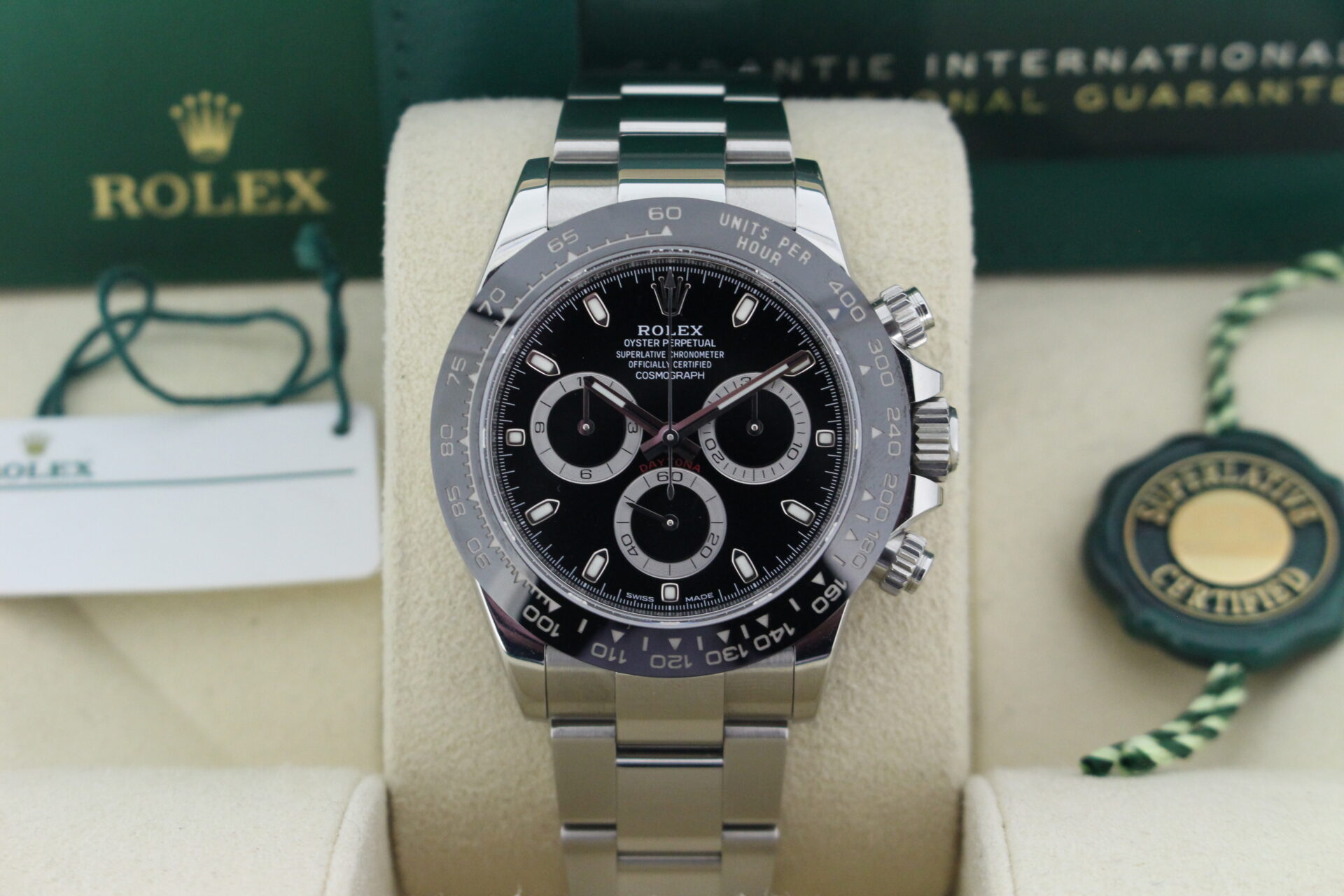 Close up of Rolex Daytona 116500LN in it's box with warranty card, booklets and both swing tags