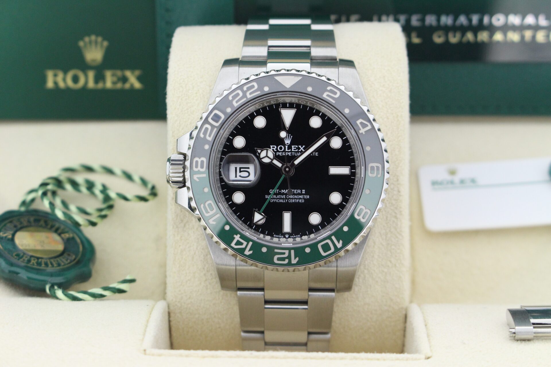 Close up of Rolex GMT Master II Sprite 126720GTNR in it's box with both swing tags, booklets and warranty card