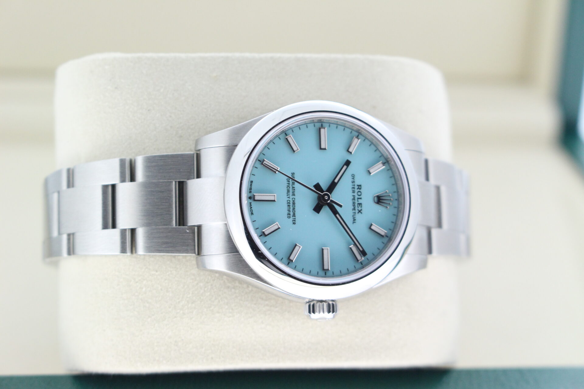 Rolex OP on its side with the tiffany dial showing off