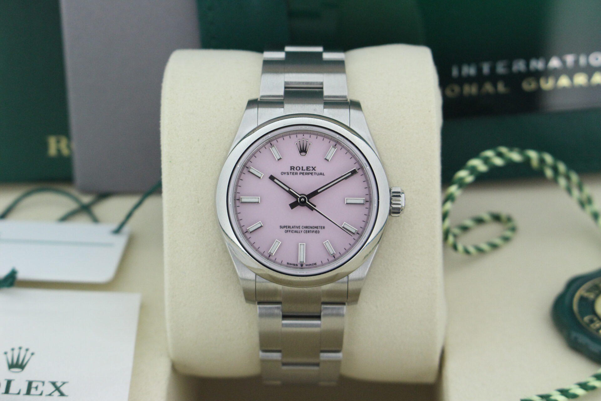 Close up of Rolex Oyster Perpetual Candy Pink Dial 277200 in it's box with both swing tags, booklets, warranty card and original purchase receipt