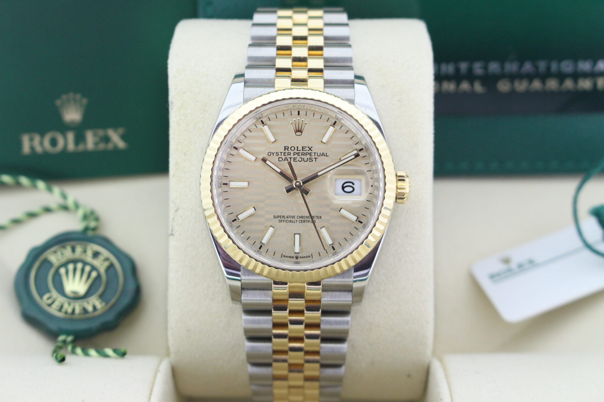 Close up of Rolex Datejust 36 Motif 126233 in it's box with both swing tags, booklets and warranty card dated April 2023