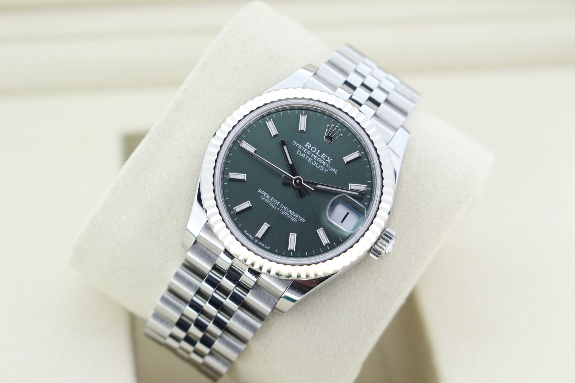 Rolex DJ 31 tilted at an angle with light reflecting on the white gold bezel