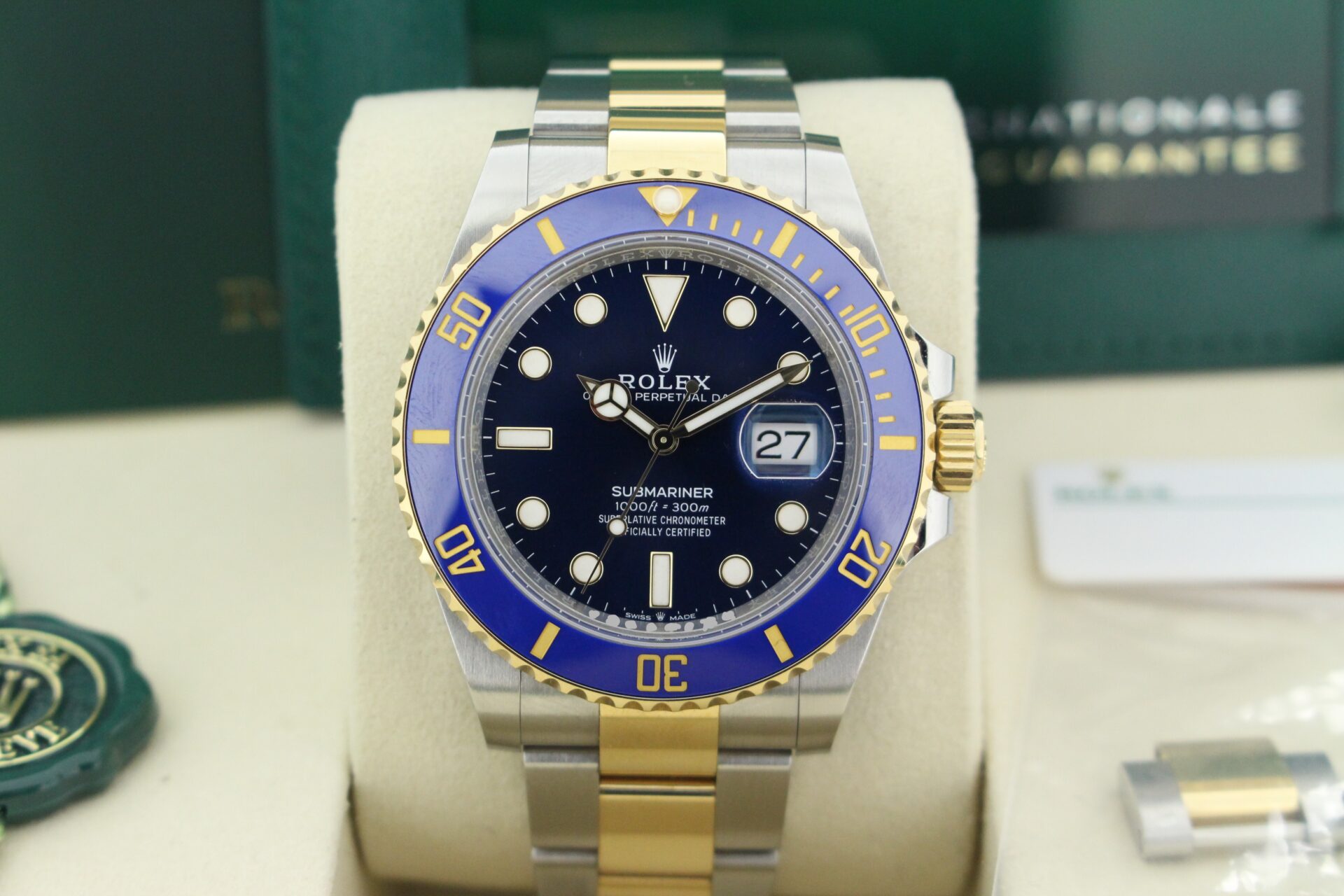 Close up of Rolex Submariner Bluesy 126613LB in it's box with both swing tags, booklet and warranty card
