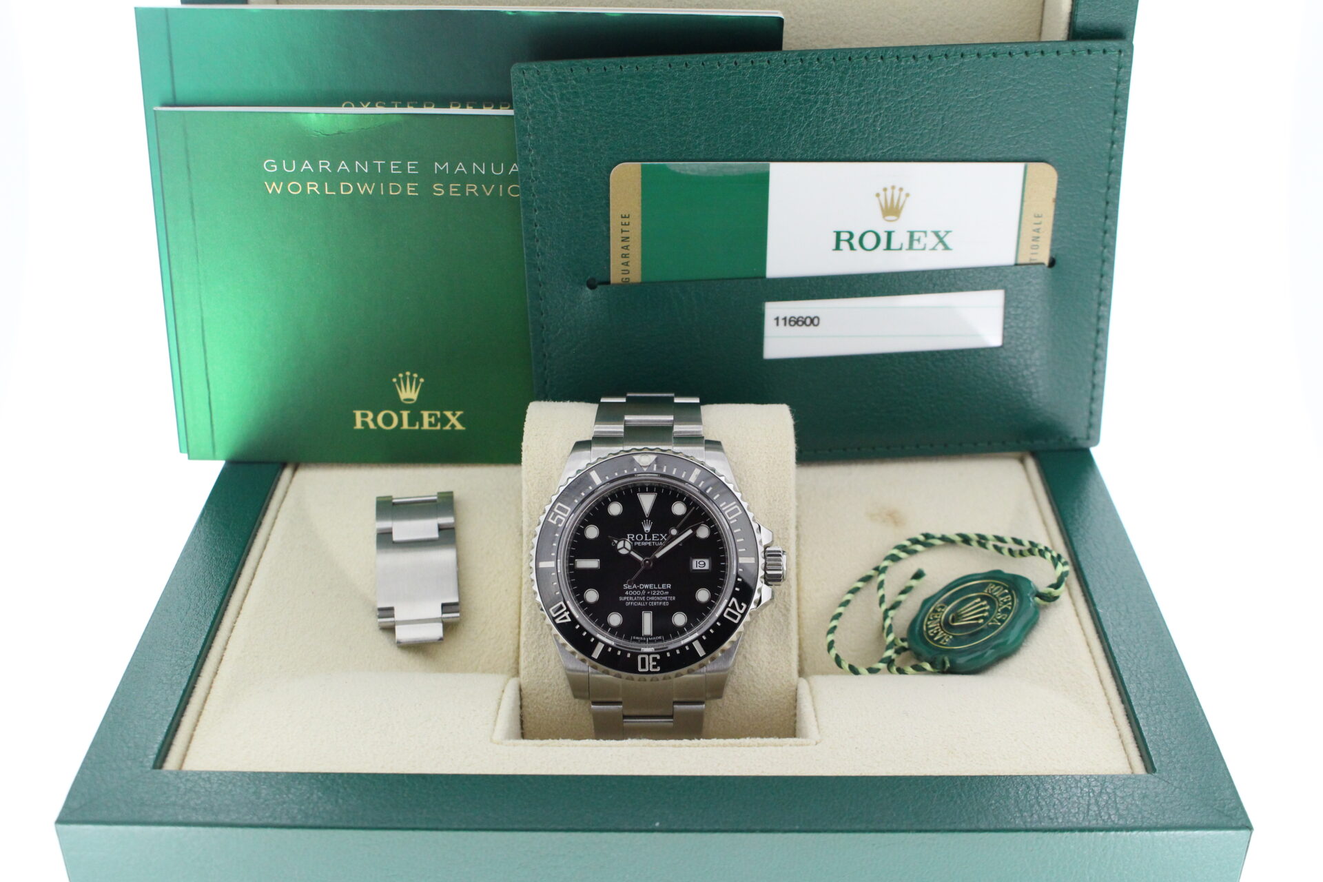 Rolex Sea-Dweller 116600 in it's box with green swing tag, booklet and warranty card