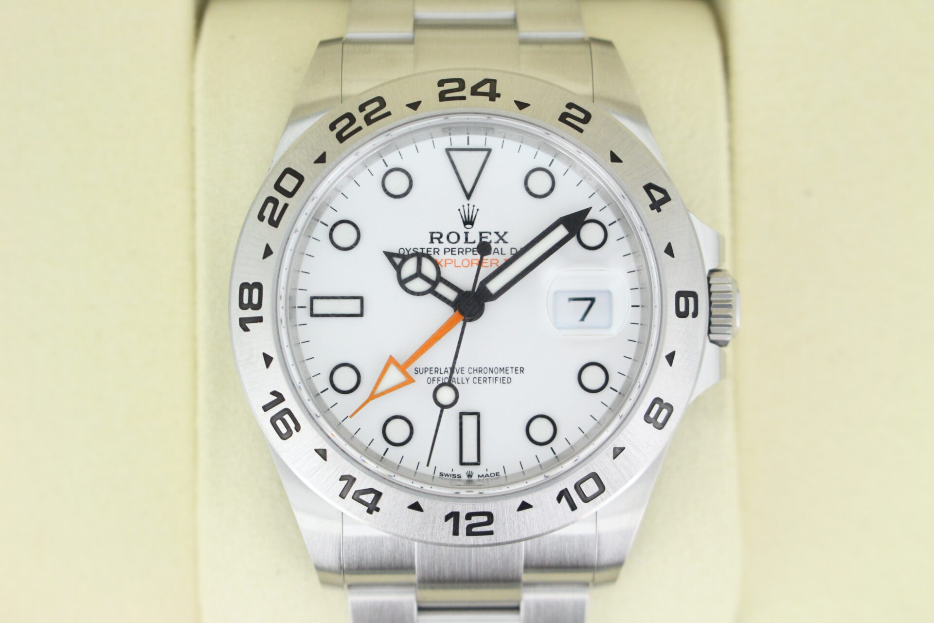 Close up picture of Rolex Explorer II with a white dial and orange seconds hand